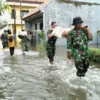 TNI bersama bpbd dan warga gotong royong membuat tanggul darurat di Sungai Meduri
